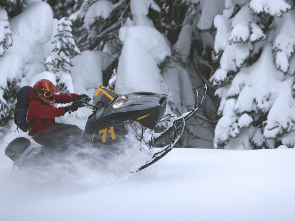 Snowmobile doing wheelie in deep snow