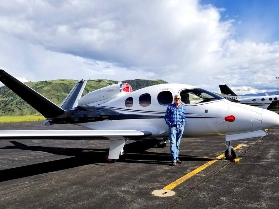Man standing in front of private plane